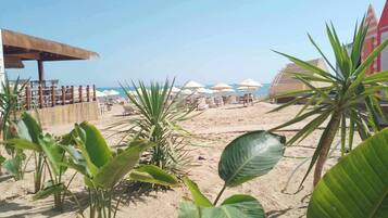 Private beach, white sand, sun loungers, beach umbrellas