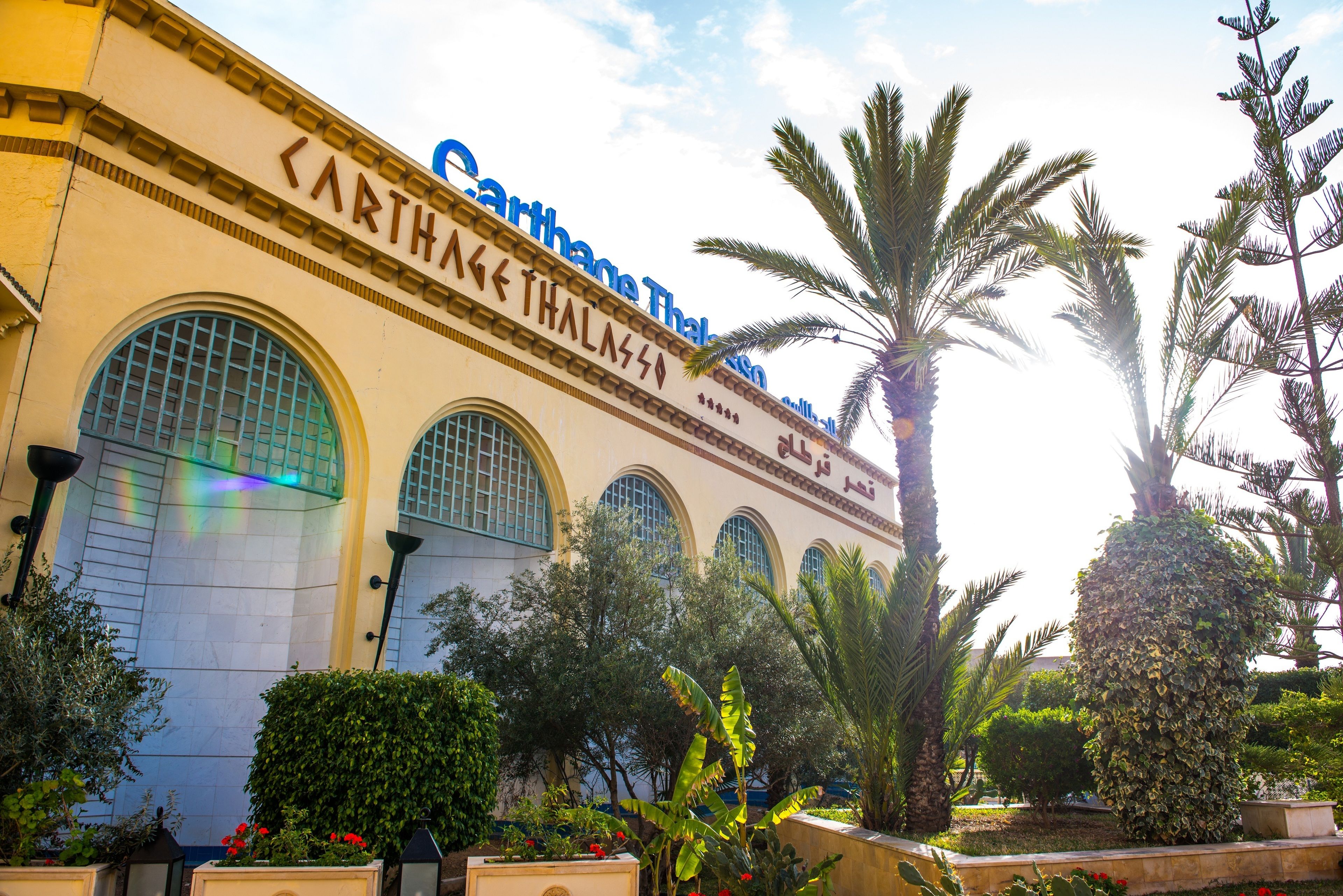 A building with large arched windows and a sign that reads "Carthage Thai".