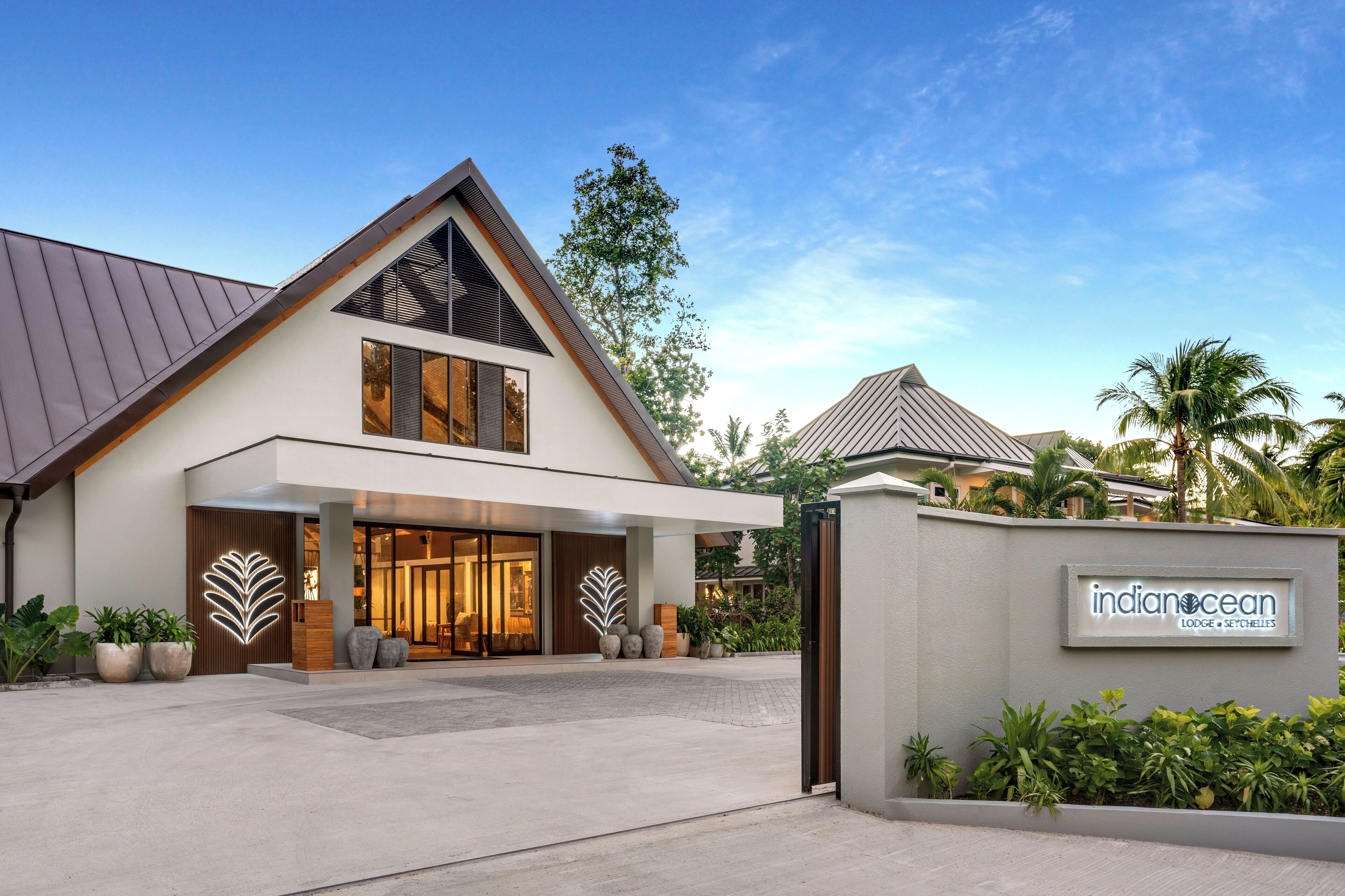 A modern hotel entrance with a large sign reading "indian ocean lodge & setchelles".