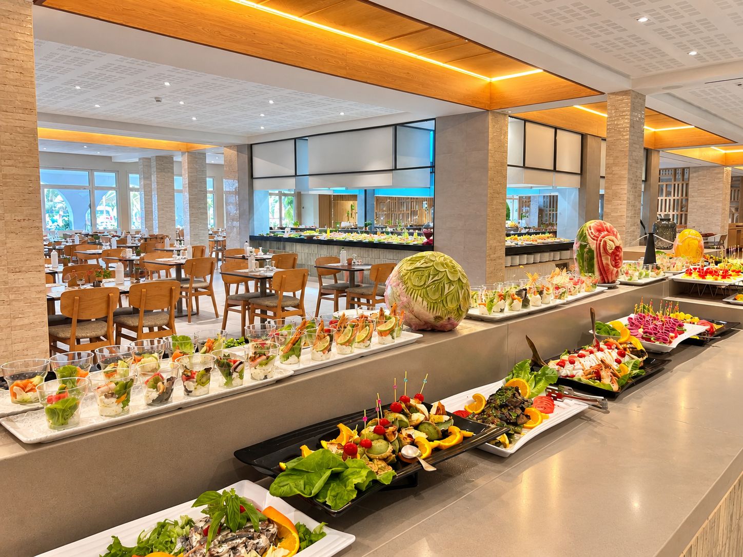 A buffet with various food stations, including a salad bar and a seafood section.
