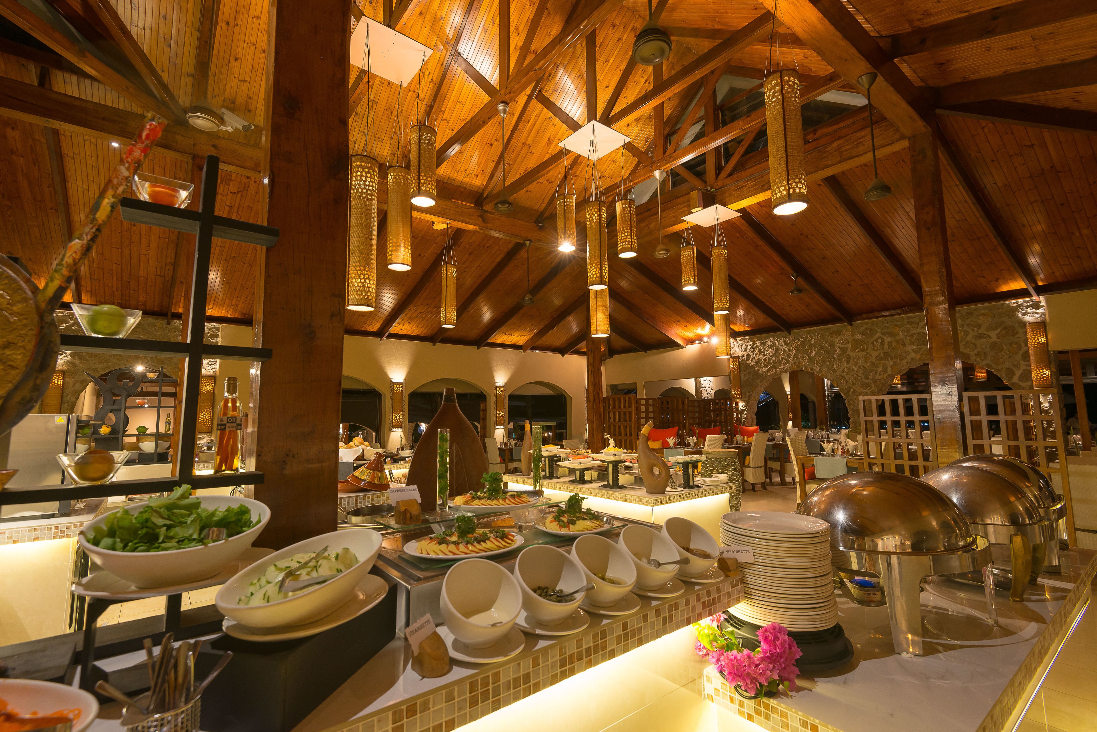 A buffet setup with various food items and serving dishes.