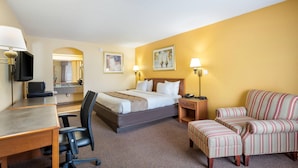 A hotel room with a bed, desk, chair, and sofa. - Quality Inn White Springs Suwanee (White Springs)
