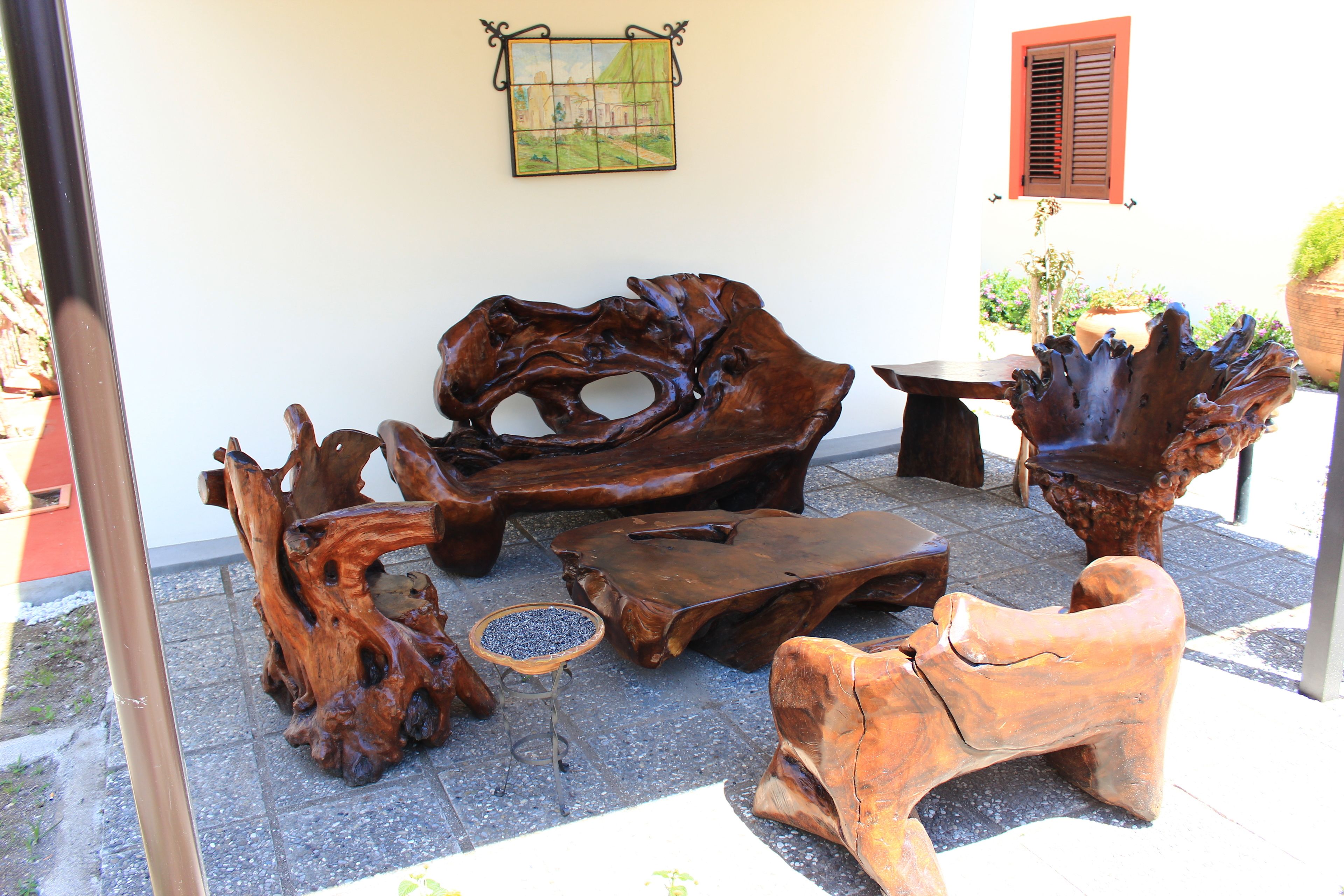 A patio area with rustic wooden furniture, including a bench and a table.