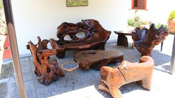 A patio area with rustic wooden furniture, including a bench and a table.