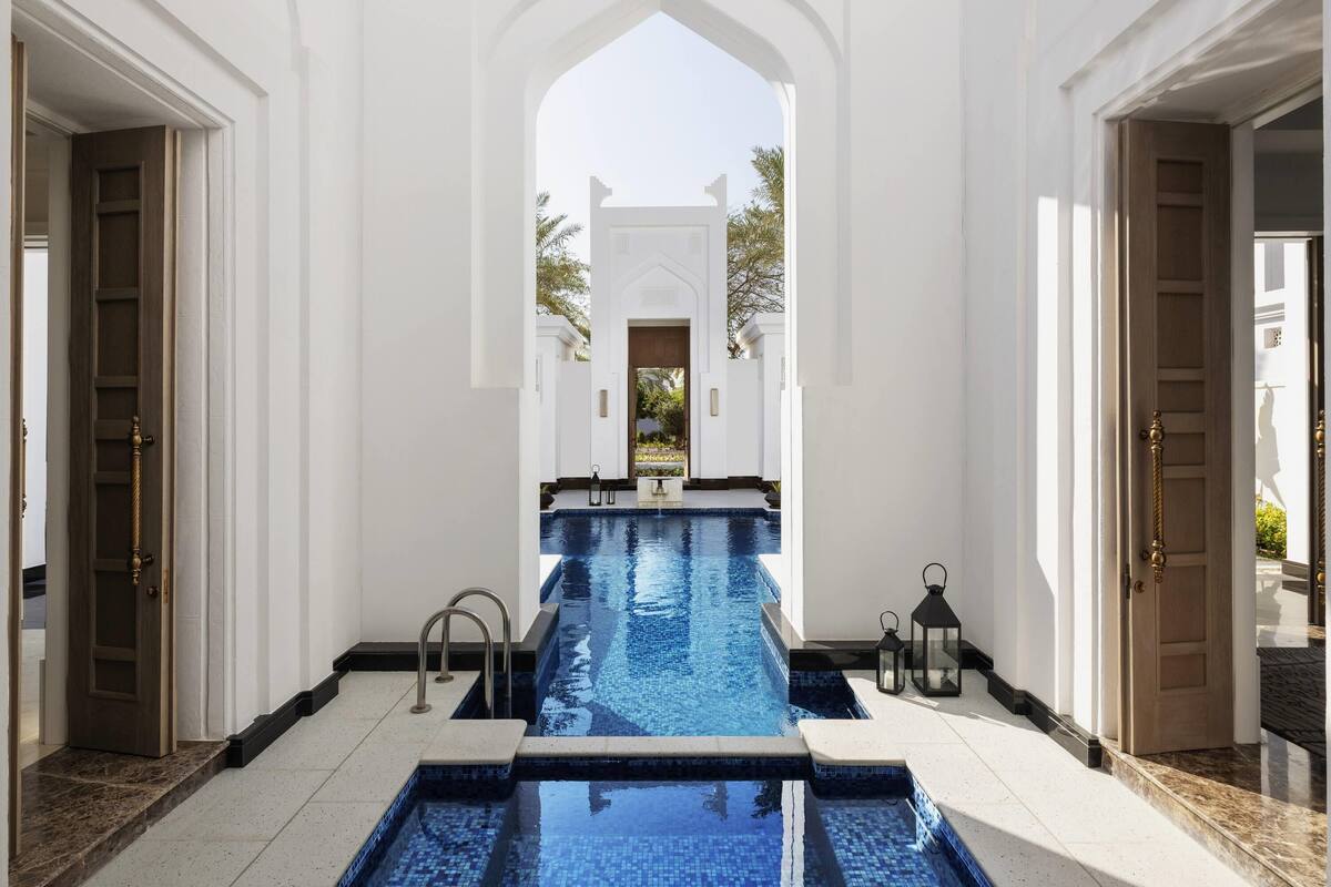 A pool area with a clear view of the pool, a door on the left, and a door on the right.