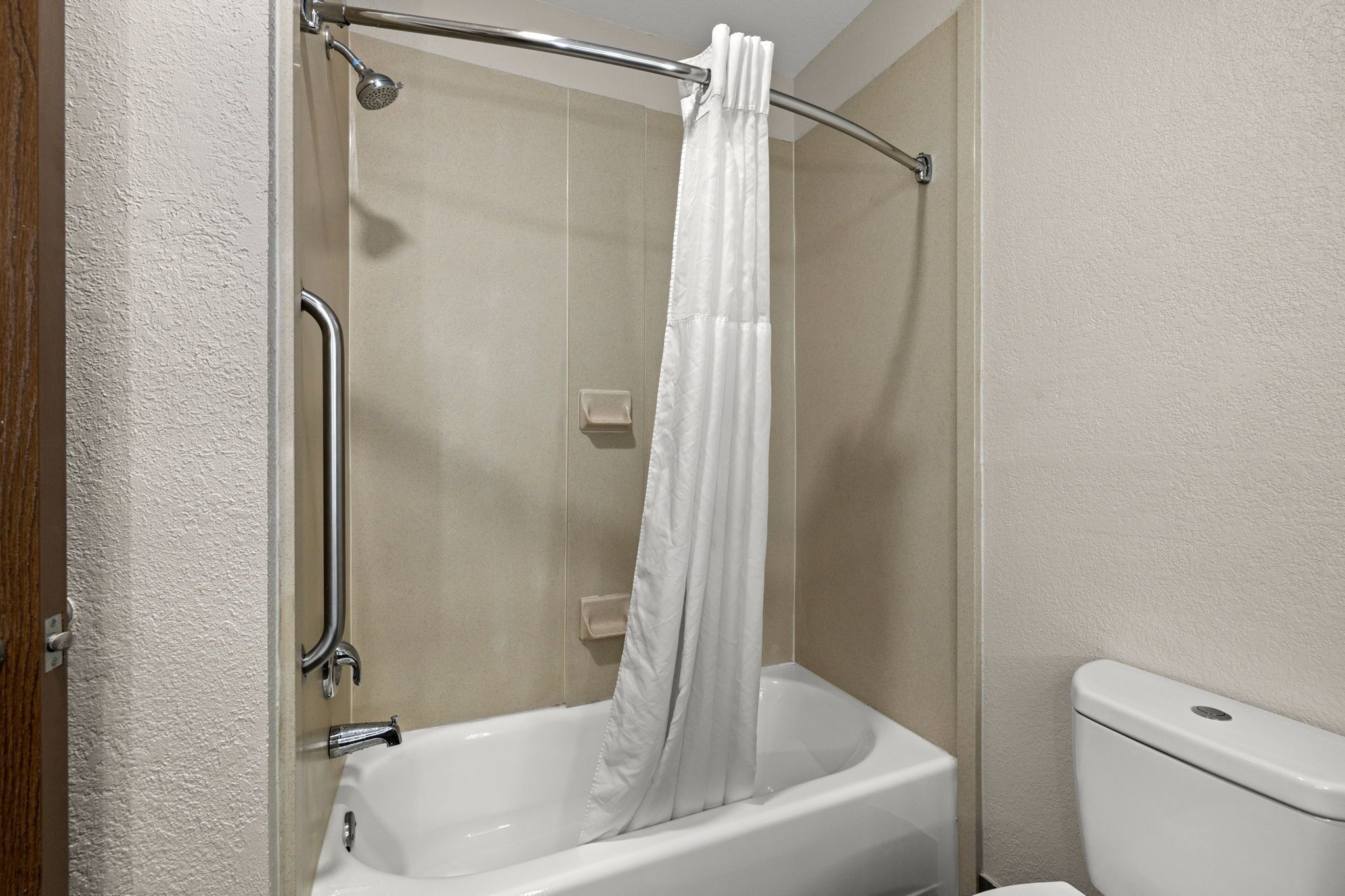 A bathroom with a bathtub, a shower, and a toilet.