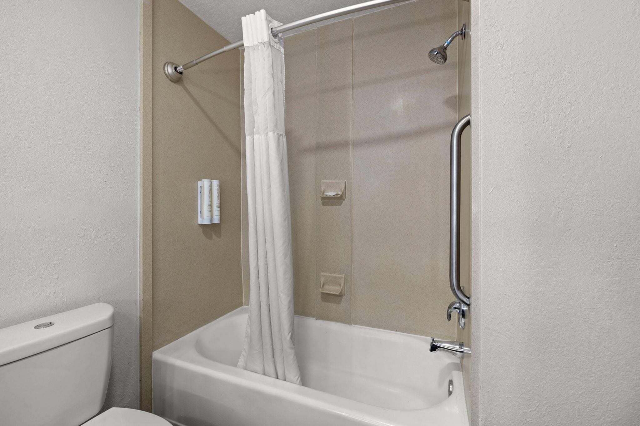 Un baño con bañera, ducha e inodoro.