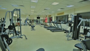 A gym with treadmills, weight machines, and free weights. - Grand Mir Hotel (Tashkent)