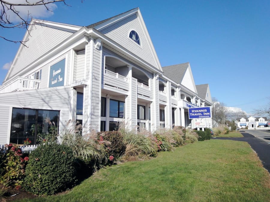 A two-story building with a prominent sign for Hyannis Travel Inn.
