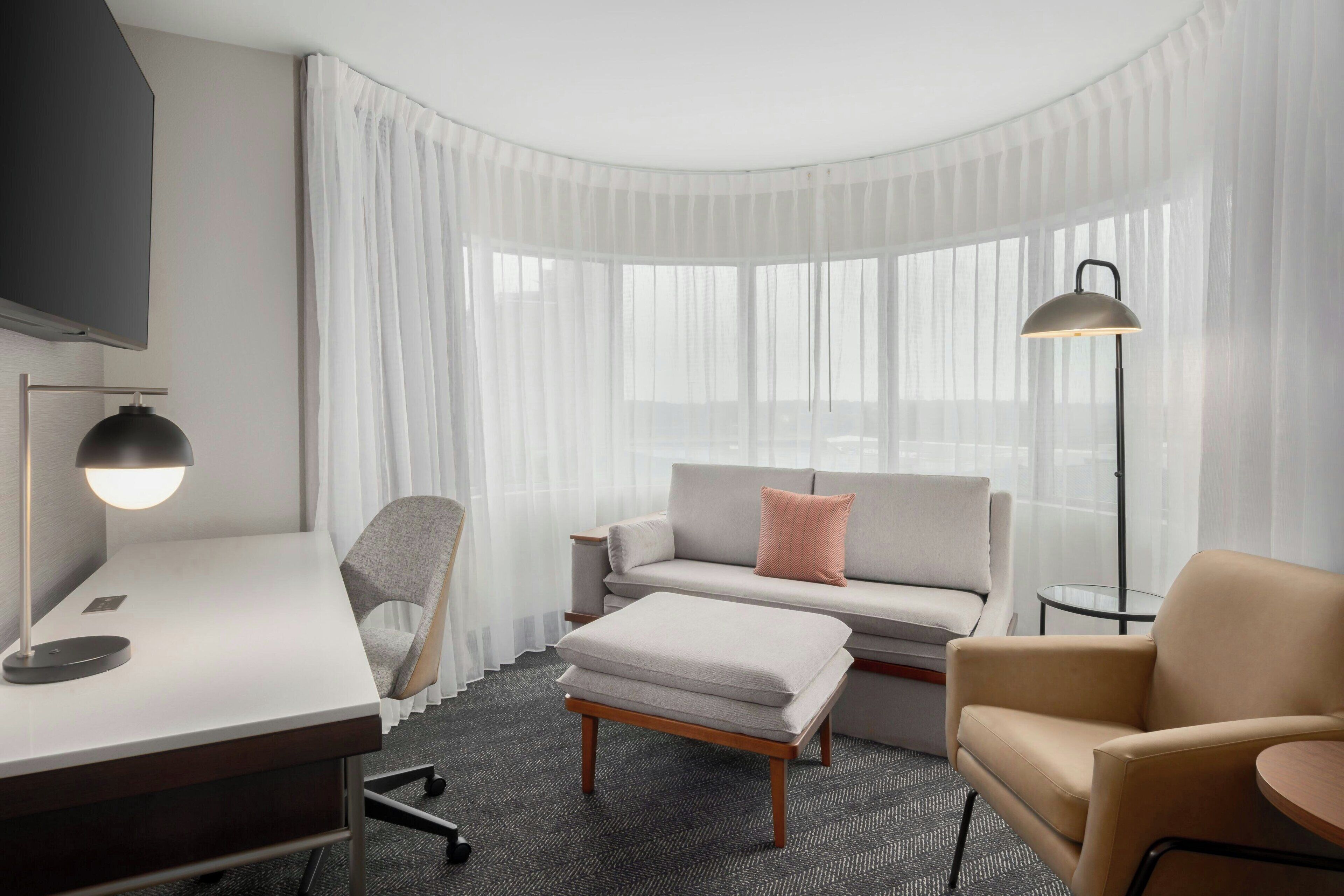 suite, 1 king bed with sofa bed, corner | living area | 55-inch flat-screen tv with cable channels, tv, netflix