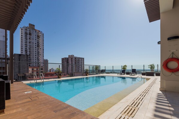 Outdoor pool, open 7:00 AM to 10:00 AM, pool umbrellas, sun loungers