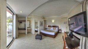 A hotel room with a bed, a TV, a desk, and a dining area. - Best Western Taxco (Taxco)