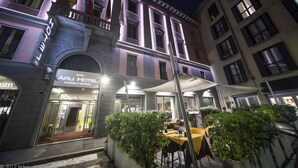 A hotel with a classic facade, outdoor seating area, and a sign indicating it is a business and wellness hotel. - Arli Hotel Business and Wellness (Bergamo)
