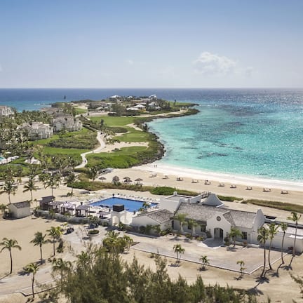 A resort with a pool, beach, and ocean view.