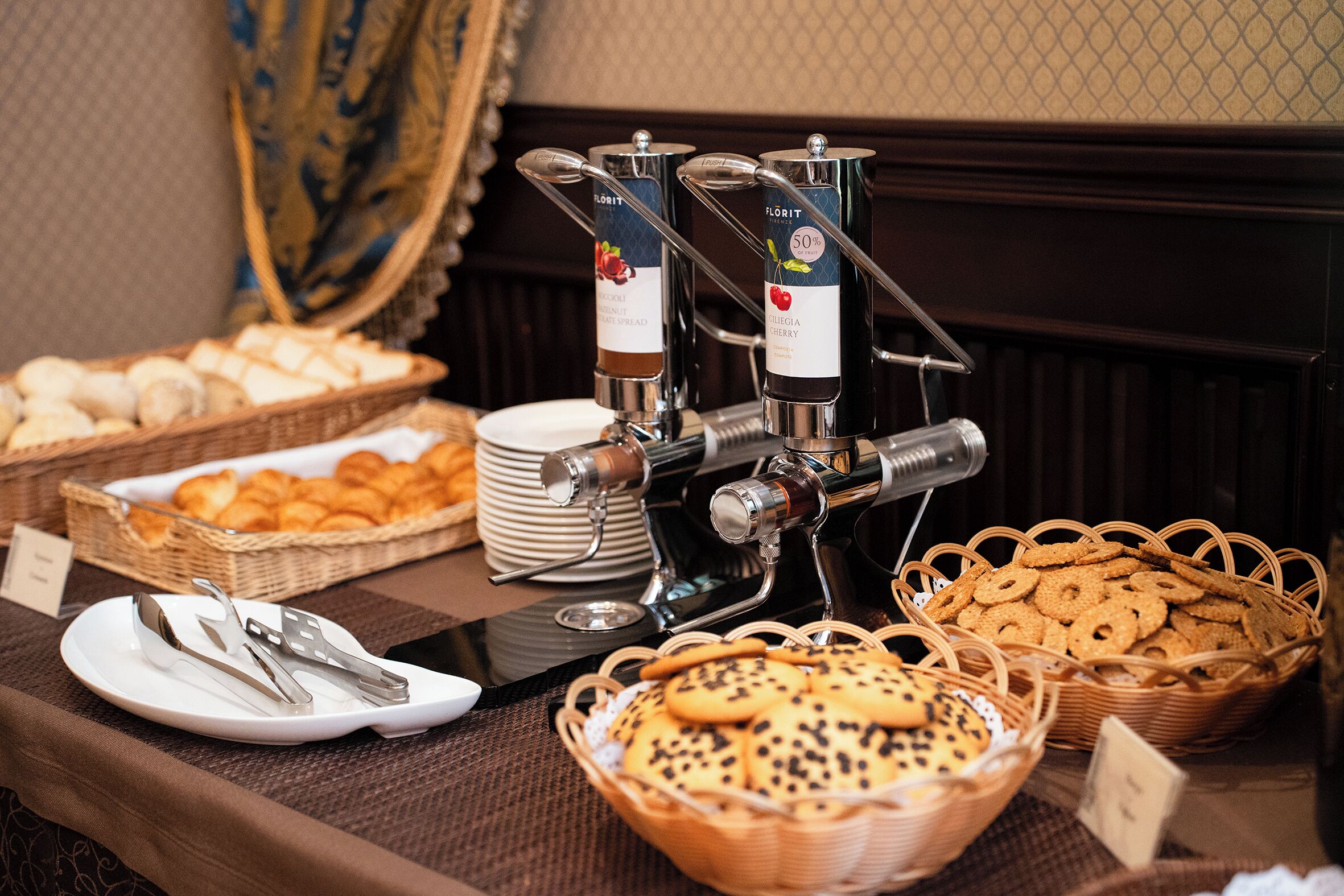 A buffet setup with various food items and a coffee station.