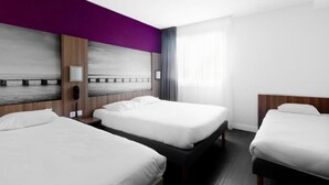 A hotel room with three beds, a large window with curtains, a view of the sea, and a purple accent wall. - Brit Hotel Confort Montpellier Parc Expositions (Perols)