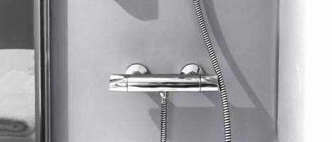 A modern shower with a handheld showerhead and a handheld hose.
