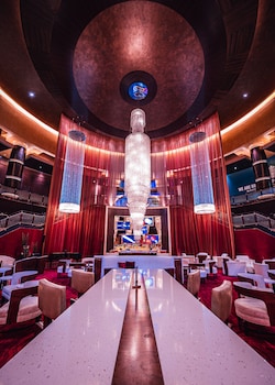 A modern living room with a large window, a kitchen area, and a seating arrangement. at Red Rock Casino, Resort and Spa