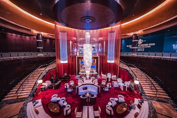 A cozy lounge area with leather sofas, wooden coffee tables, and pendant lighting. at Red Rock Casino, Resort and Spa