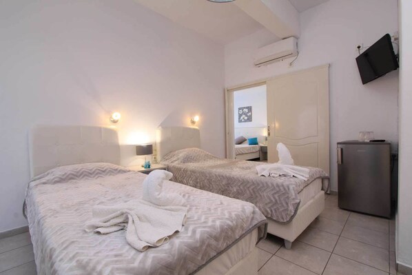 Quadruple Room, 2 Bedrooms | In-room safe, blackout drapes, iron/ironing board, free WiFi