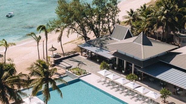Ett semesterhotell med pool, strand och utsikt över havet.