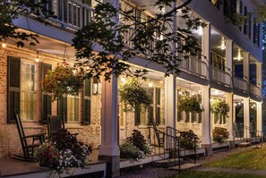 A two-story house with a covered porch, brick walls, and hanging flower baskets. - Grafton Inn (Grafton)