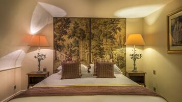 A hotel room with a large bed, two nightstands, two lamps, and a painting on the wall.