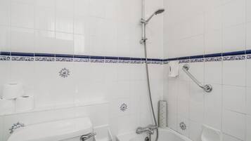 A bathroom with a bathtub, a shower, and a toilet.