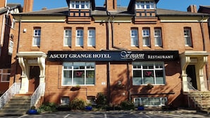 A two-story building with a sign for Ascot Grange Hotel and Voyon Restaurant.