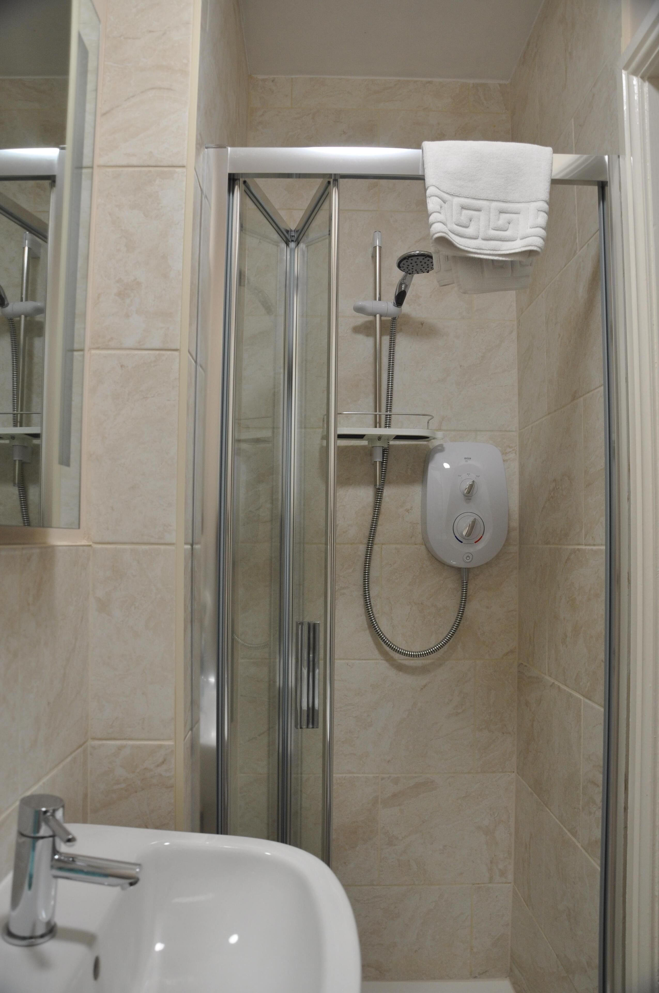 shower, hair dryer, towels, shampoo