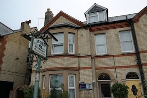 A corner building with a sign for 'ACORN' and a 'WORLD HOUSE' sign. - Acorn Guest House (Cambridge)