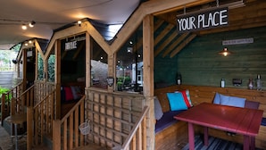 A cozy wooden interior with a bench and a table, wooden beams, and a sign that says "YOUR PLACE". - The Dukes Head Hotel (Wallington)