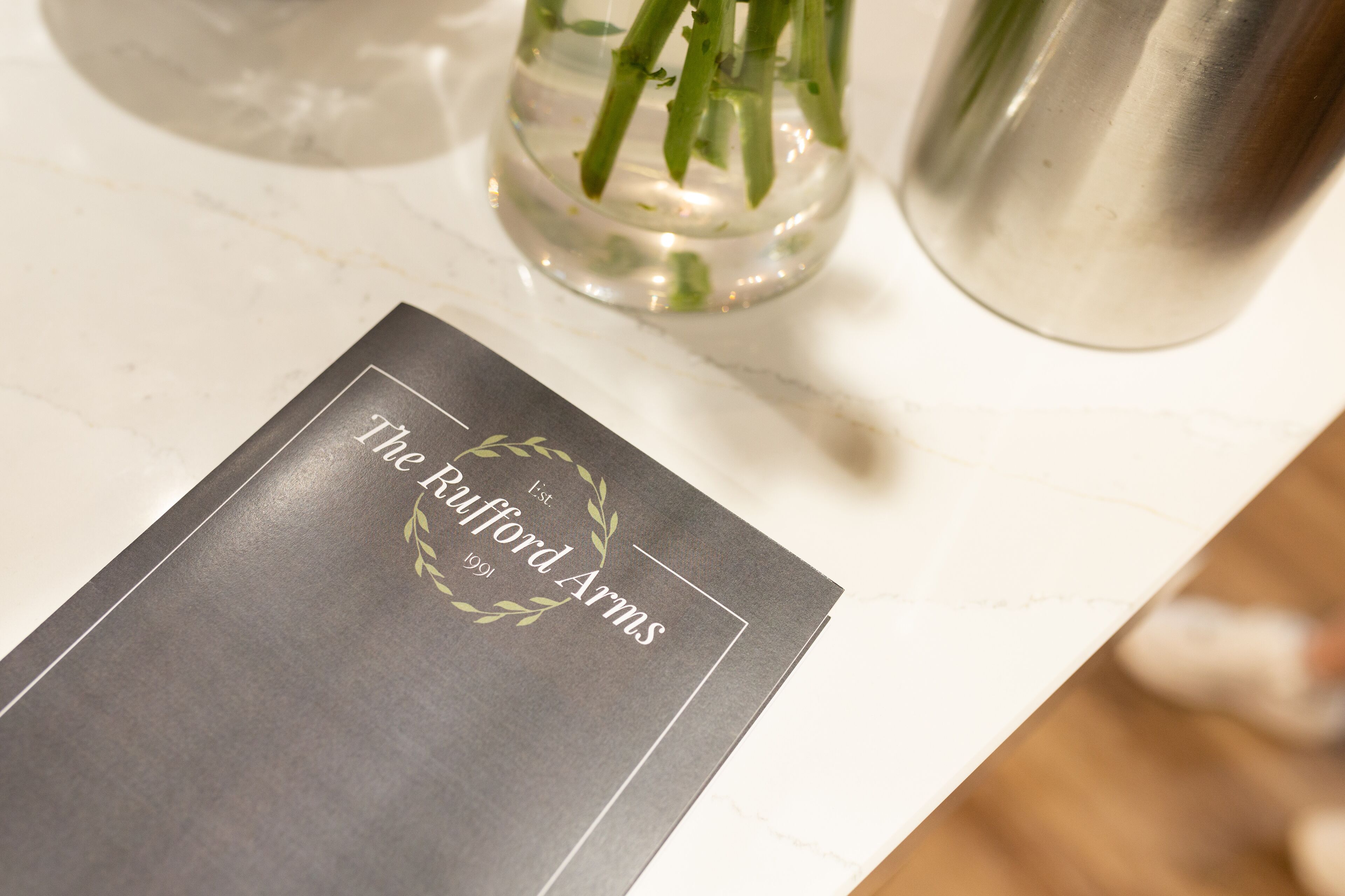 A menu with the text "The Rufford Arms" on a marble table.