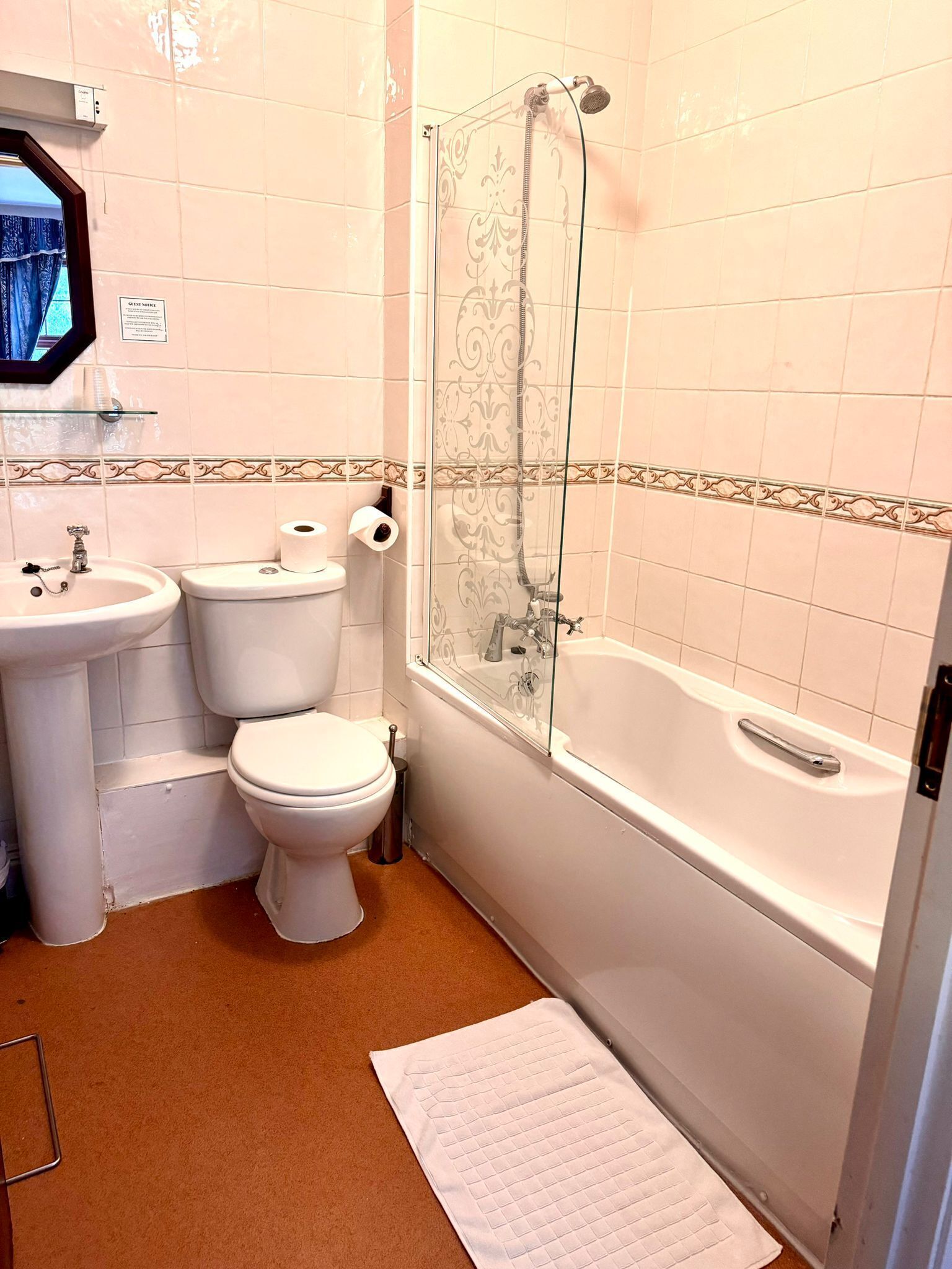 A bathroom with a toilet, sink, and bathtub.