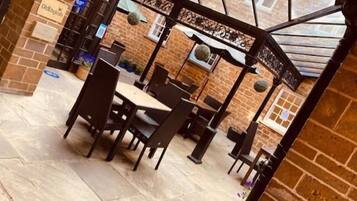 Un restaurant aux murs de briques, doté d’une verrière et d’une enseigne indiquant « Old English ».
