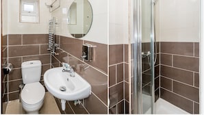 A bathroom with a toilet, sink, and shower. - Abbey Hotel Shepherd’s Bush (London)