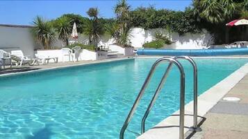 Seasonal outdoor pool, pool loungers