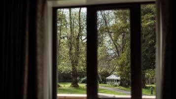 A view through a window of a park with a gazebo.
