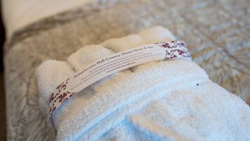 A neatly folded towel with a label on a textured surface.