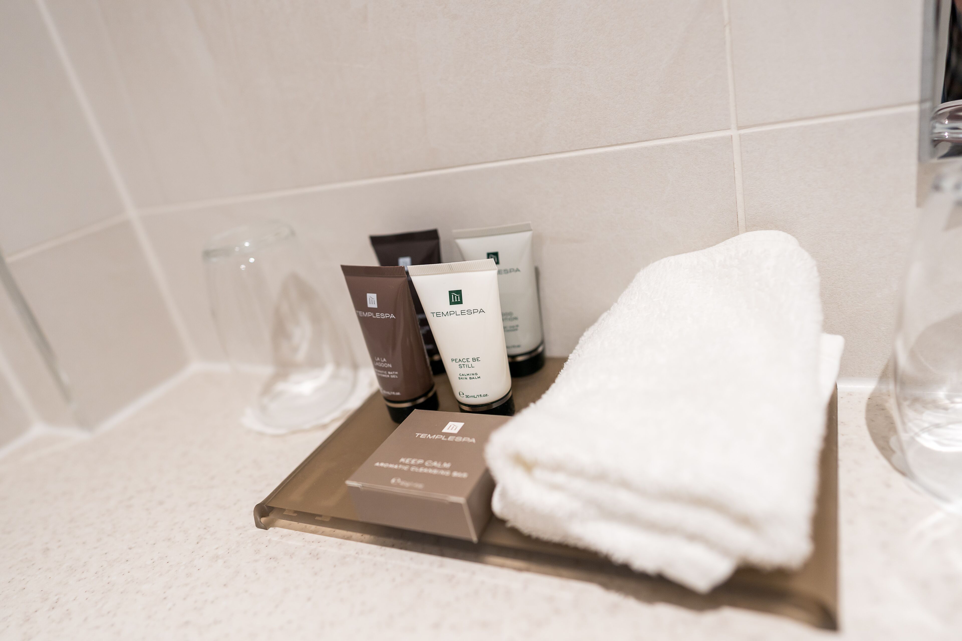 A bathroom counter with toiletries and a towel.