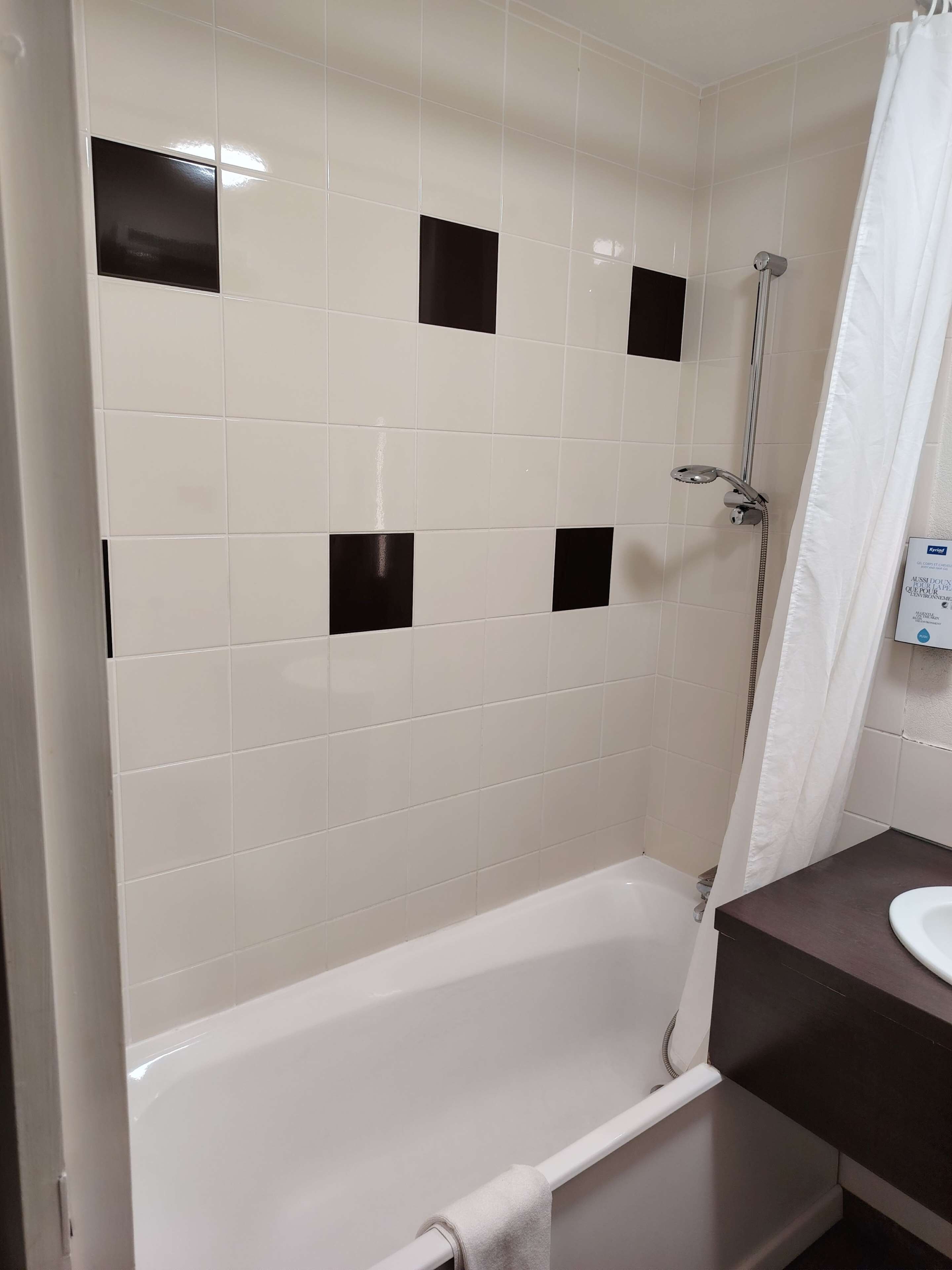 A bathroom with a bathtub, a shower, and a sink.