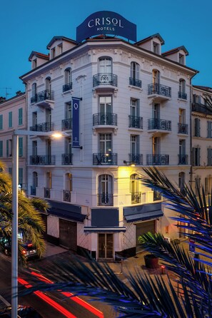A multi-story hotel with a prominent sign reading 'CRISOL HOTELS.'