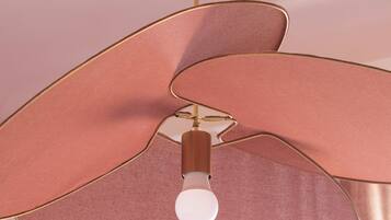 A pendant light fixture with a unique, abstract design.