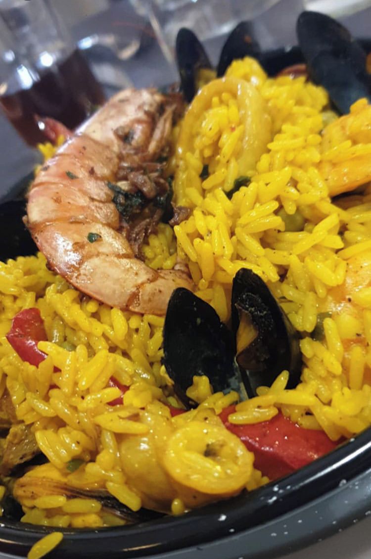 A seafood paella with shrimp and mussels.
