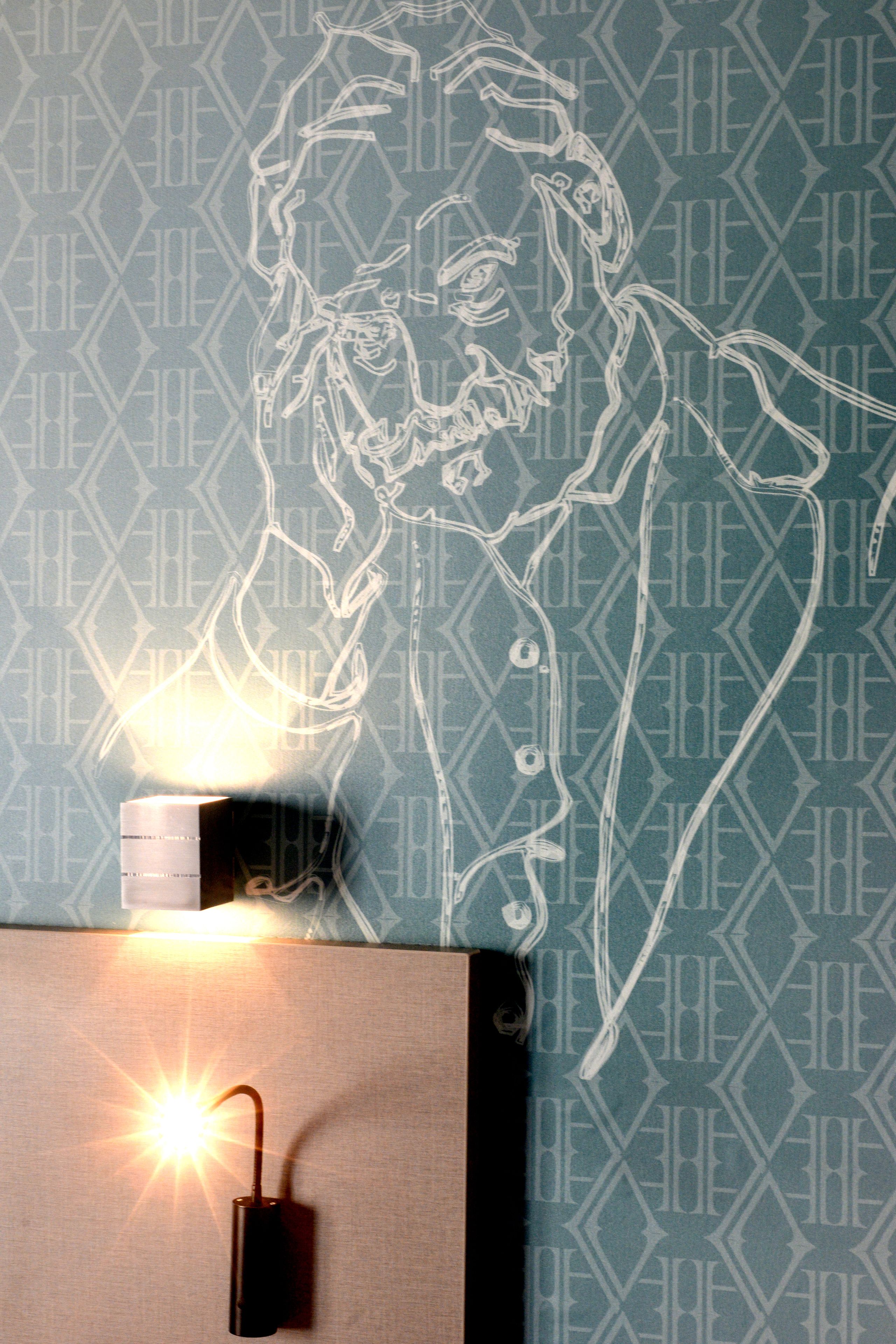 A wall with a geometric pattern and a line drawing of a person.