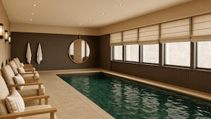A swimming pool with a row of chairs on one side, a round mirror, and a window with blinds. - Le Goyen (Audierne)