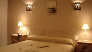 A neatly made bed with pillows, two bedside lamps, and a wall-mounted artwork.