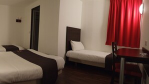 A hotel room with two beds, a small table, and a red curtain. - Enzo Hotels Mulhouse Sud Morschwiller (Morschwiller-le-Bas)
