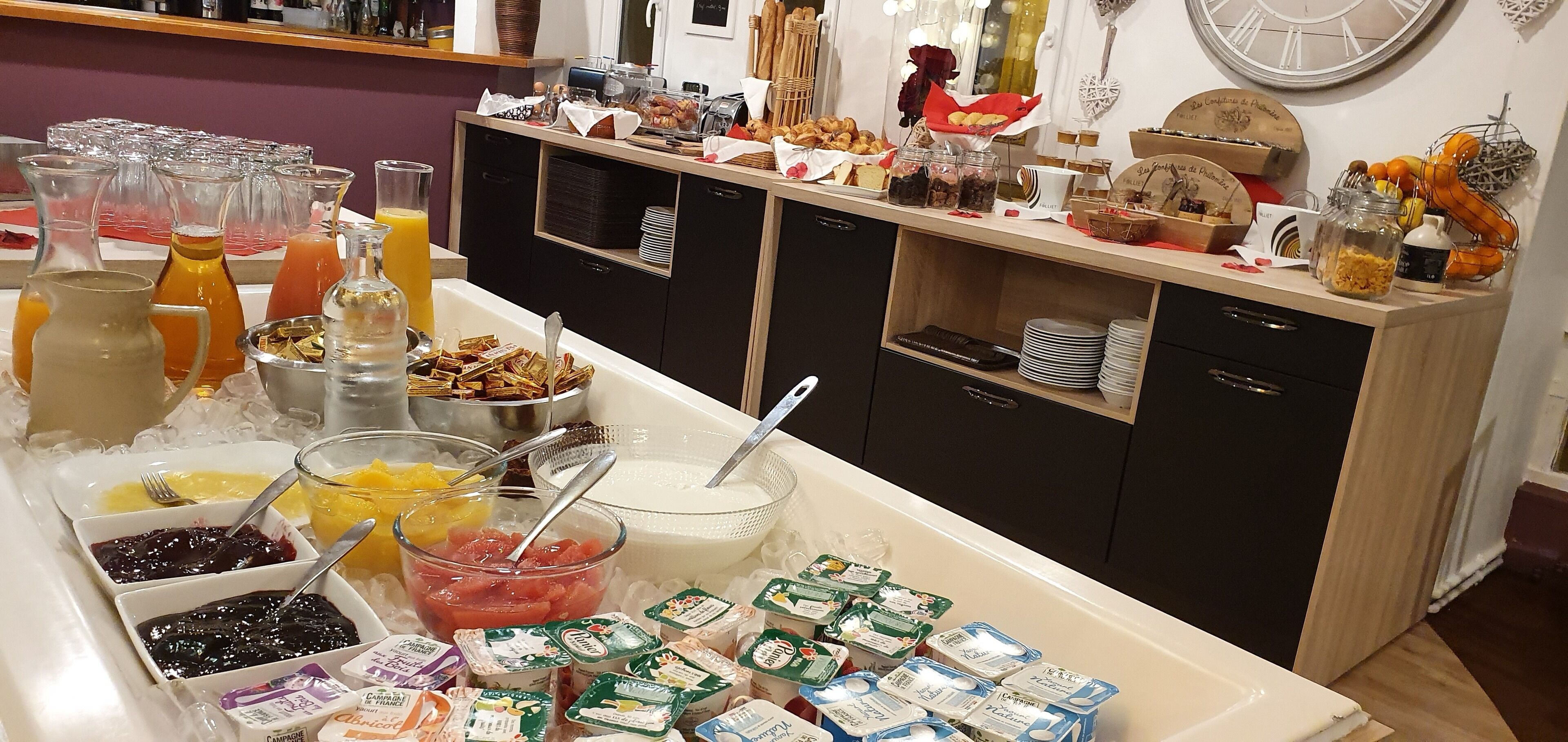 A buffet setup with various food items and beverages.