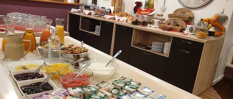 A buffet setup with various food items and beverages.